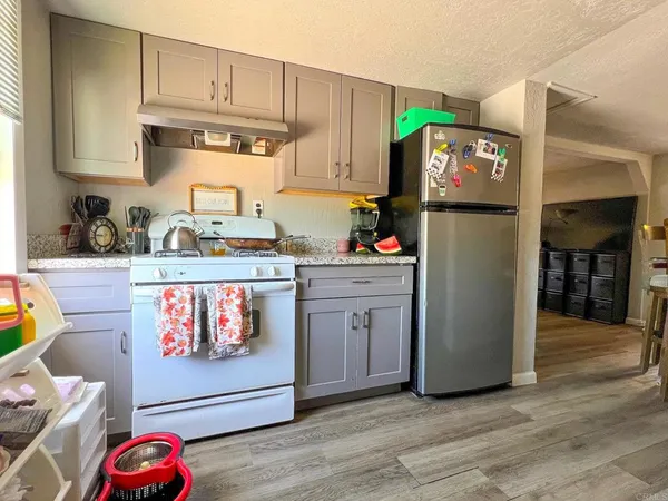 a playing room with furniture and a wooden floor