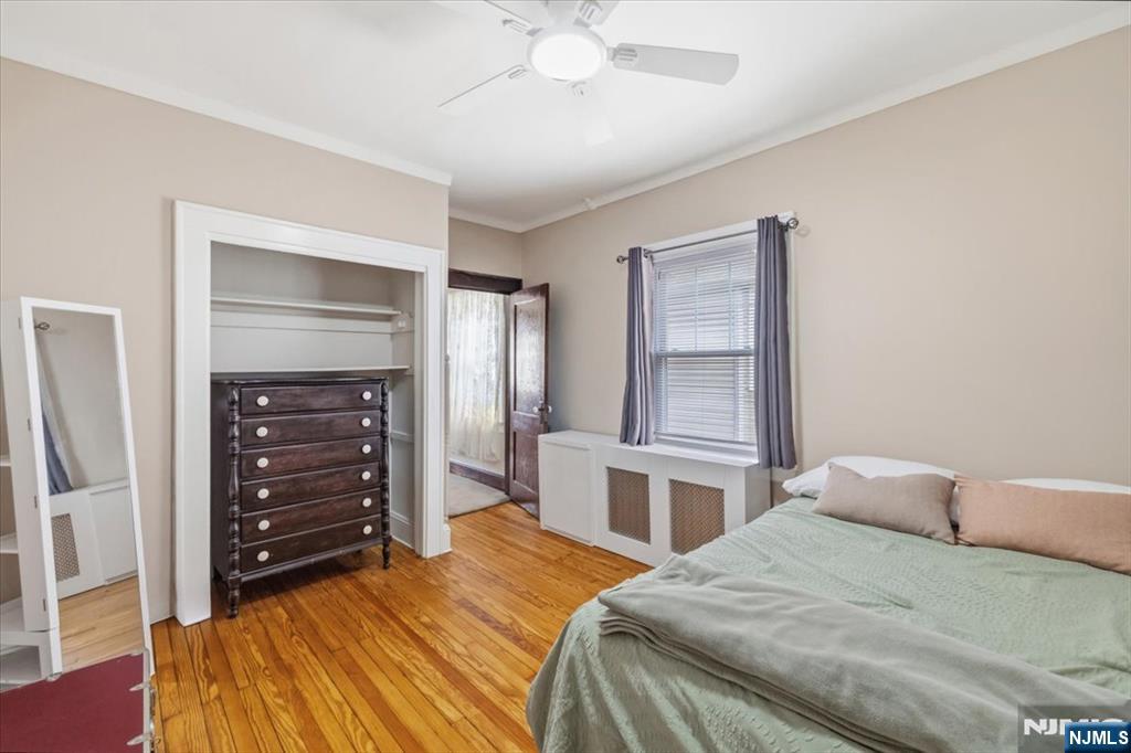 119 Overpeck Avenue Ridgefield Park, NJ 07660 - Photo 21 of 44 a bedroom with a bed and a dresser
