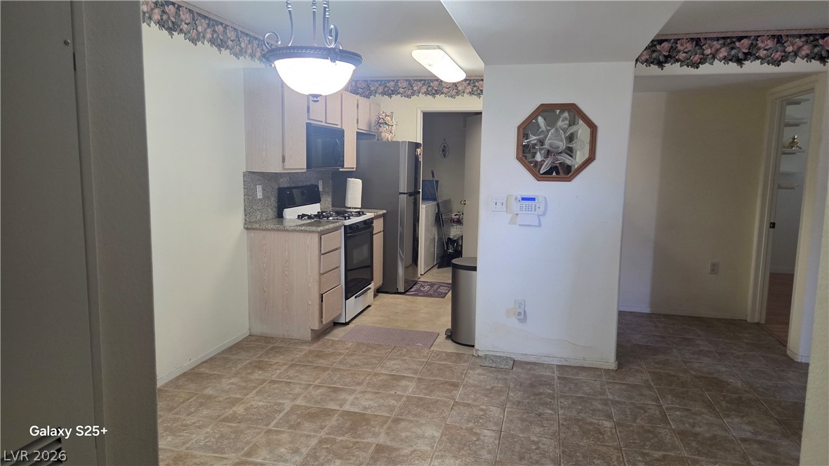 7885 West Flamingo Road, Unit 1008 Las Vegas, NV 89147 - Photo 13 of 29 Functional kitchen with ample cabinet space and durable flooring.