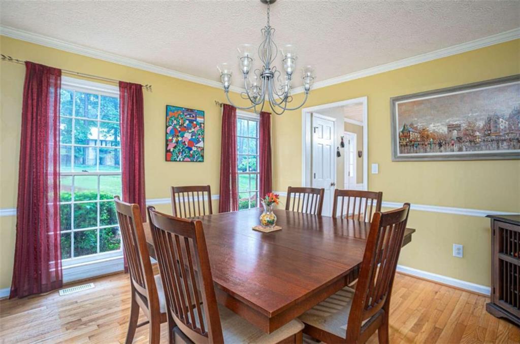 3838 Hunting Ridge Drive Southwest Lilburn, GA 30047 - Photo 7 of 56 a view of a dining room with furniture window and wooden floor