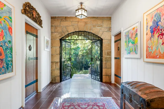 a view of entryway with a front door and wooden floor