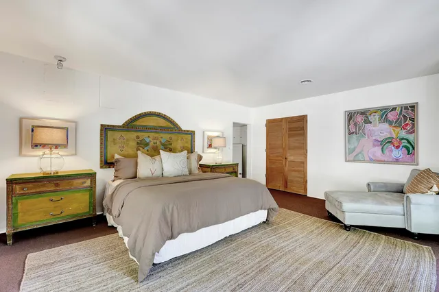 a bedroom with a bed and a couch