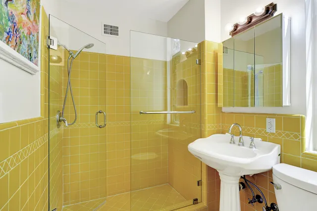 a bathroom with a sink a mirror and shower