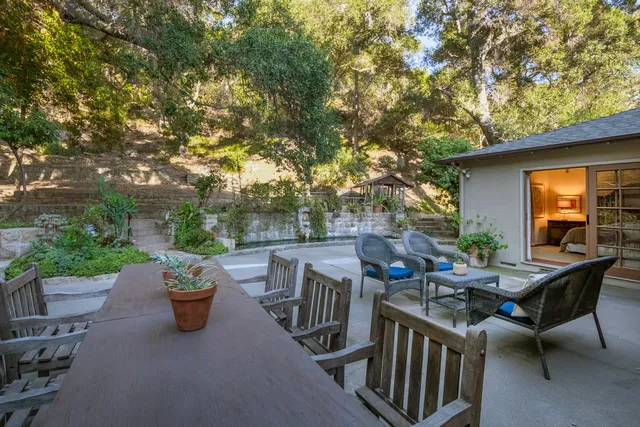 a view of a patio with a table and chairs
