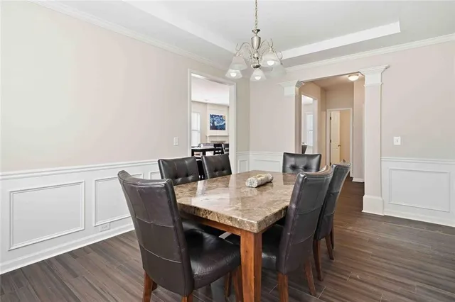 a view of a dining room with furniture and wooden floor