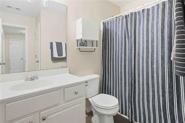 a bathroom with a sink a toilet and mirror