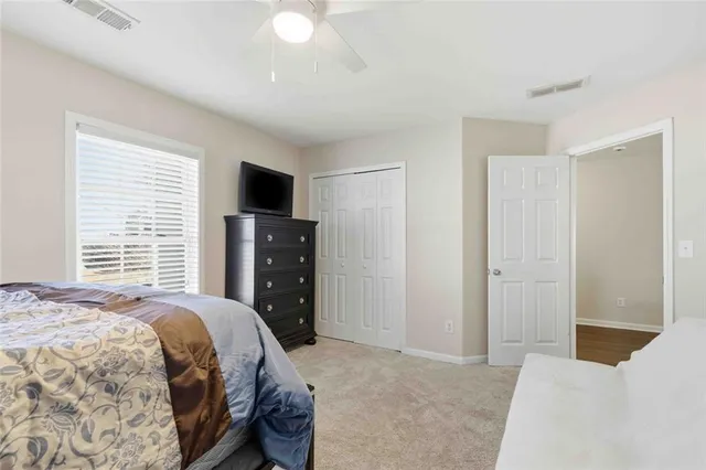 a bedroom with a bed and a television