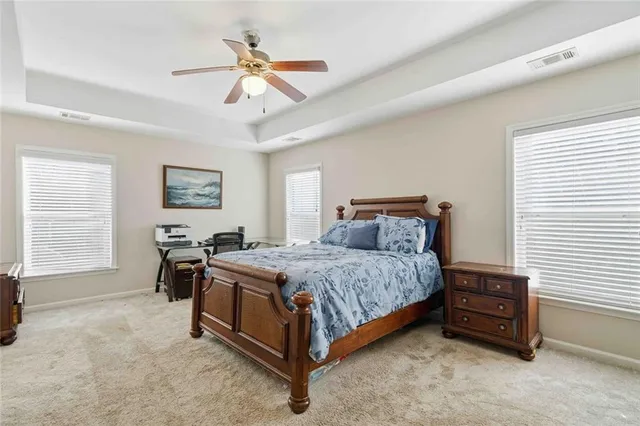 a spacious bedroom with a bed a window and closet