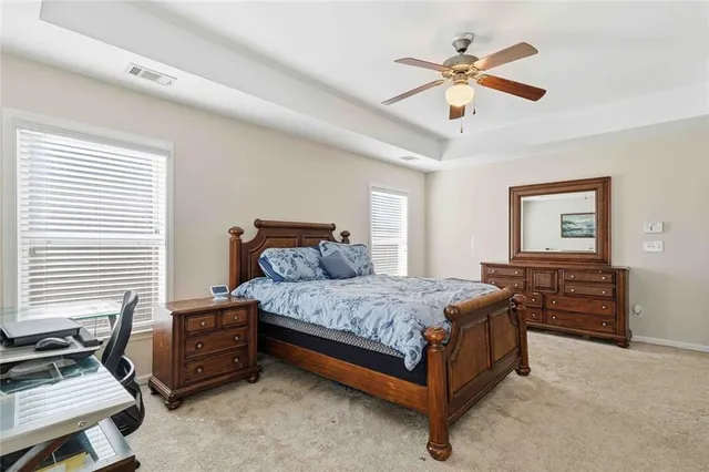 a bedroom with a bed and a ceiling fan