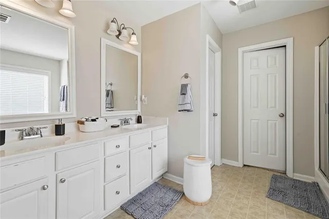 a bathroom with a double vanity sink a toilet and a mirror