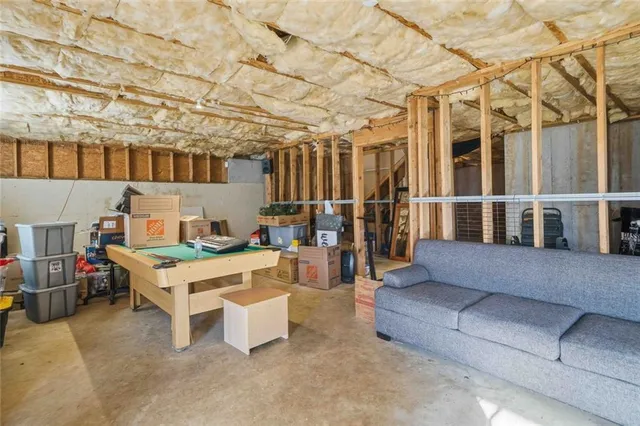 a roof deck with couches and wooden fence