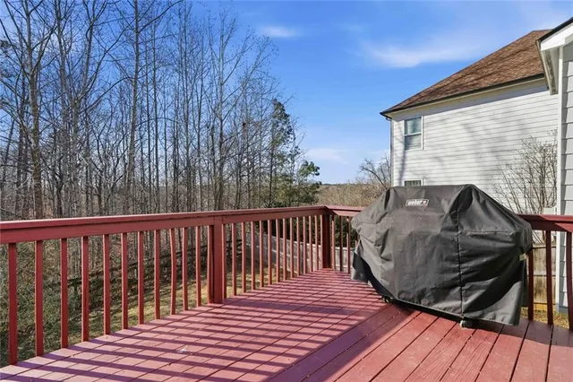 a roof deck with wooden floor and fence