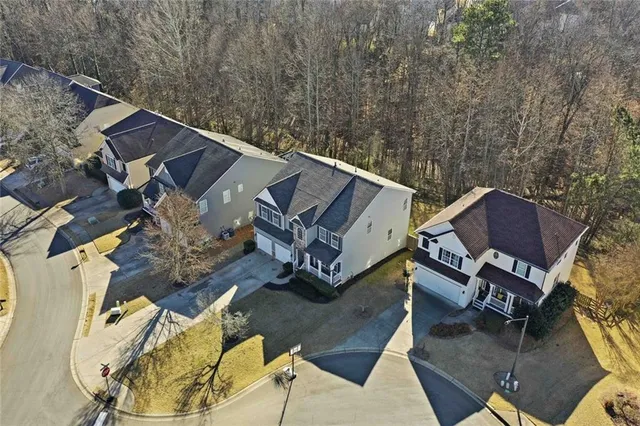 an aerial view of a backyard with table and chairs