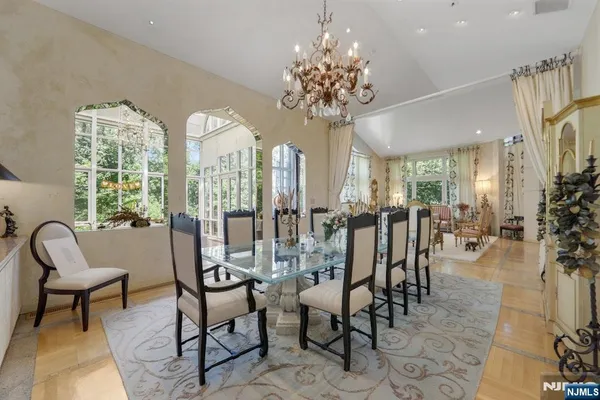 a view of a dining room with furniture and chandelier