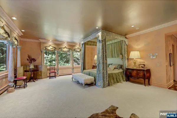 a bedroom with furniture and large windows