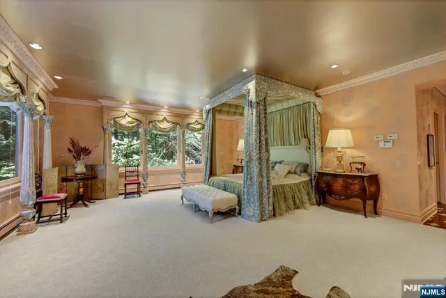 a bedroom with furniture and large windows