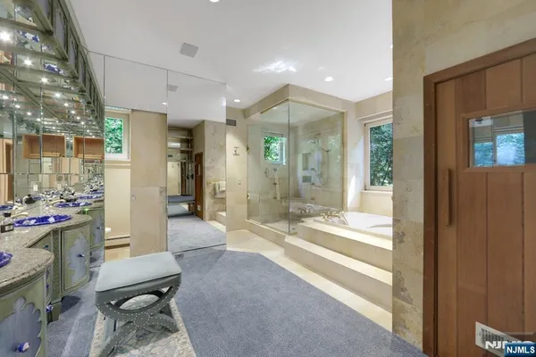 a living room with furniture a flat screen tv and a large window