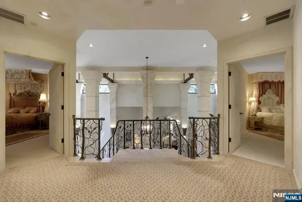 a view of a hallway with livingroom and furniture