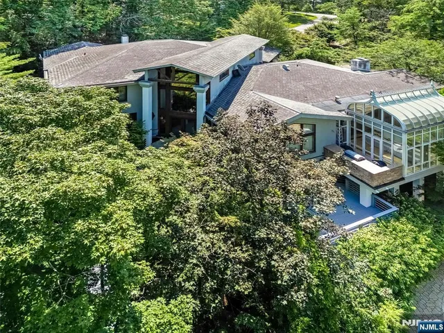 an aerial view of a house with yard and outdoor seating