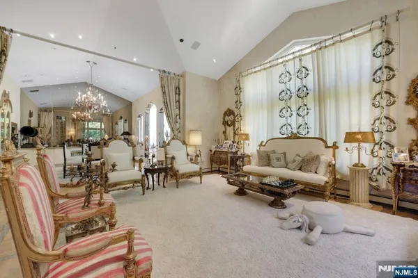 a living room with furniture and a chandelier