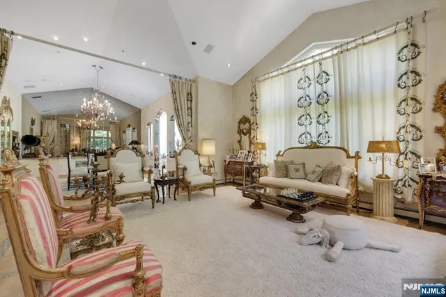 a living room with furniture and a chandelier