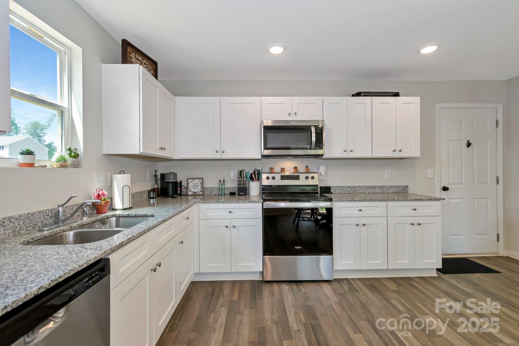 3305 Rian Drive Lenoir, NC 28645 - Photo 11 of 40 a kitchen with stainless steel appliances granite countertop a sink a stove top oven a counter space and cabinets