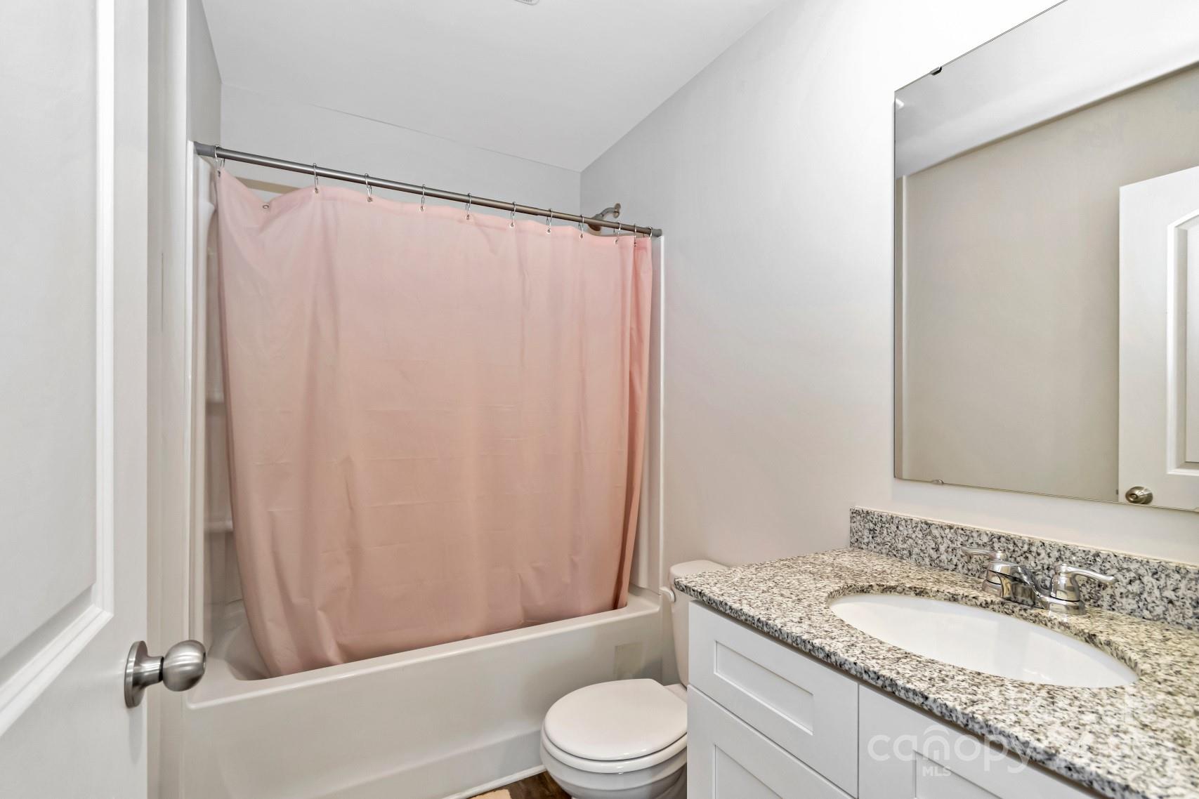 3305 Rian Drive Lenoir, NC 28645 - Photo 21 of 40 a bathroom with a granite countertop sink toilet and shower