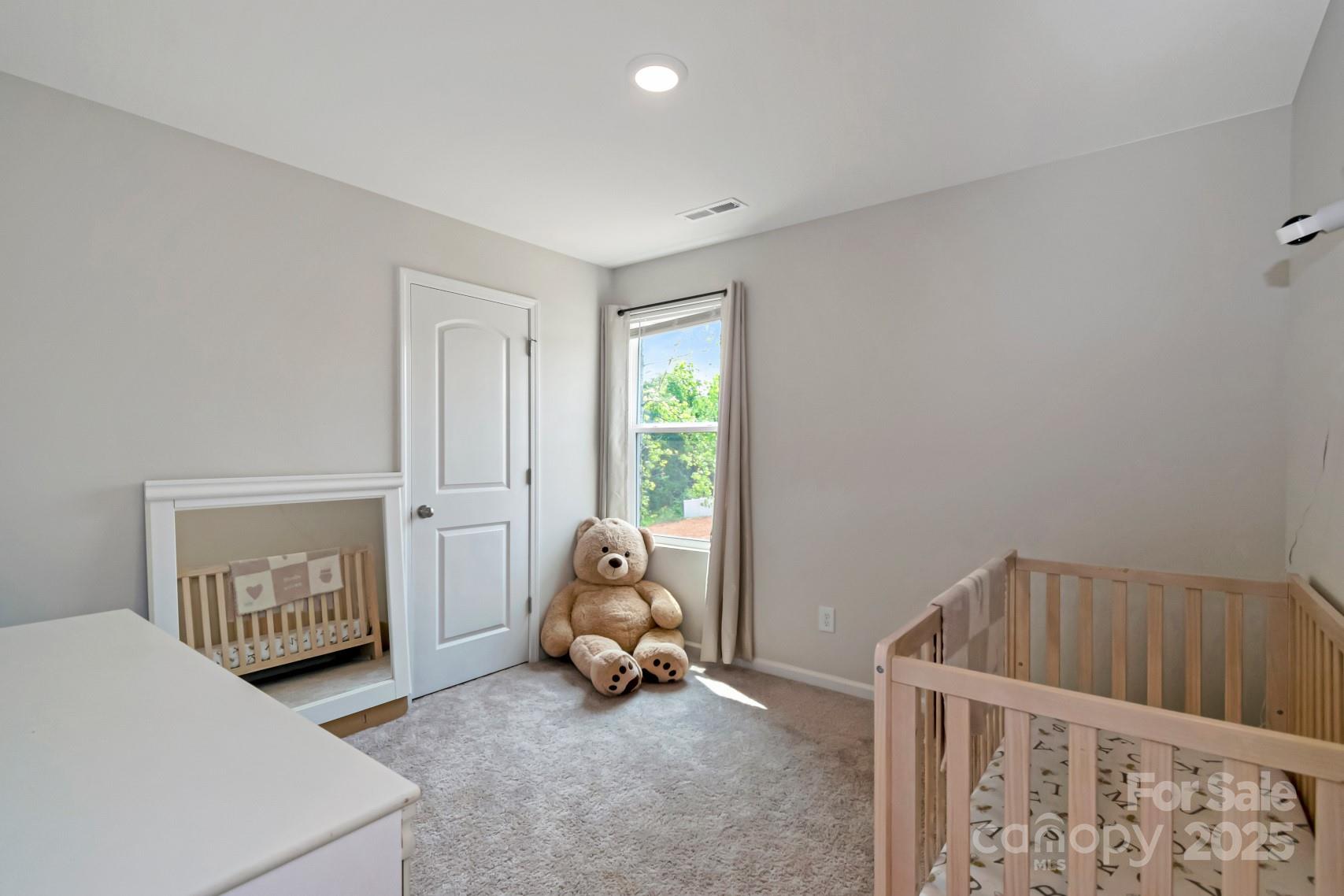 3305 Rian Drive Lenoir, NC 28645 - Photo 22 of 40 a bedroom with a baby bed a couch and a window