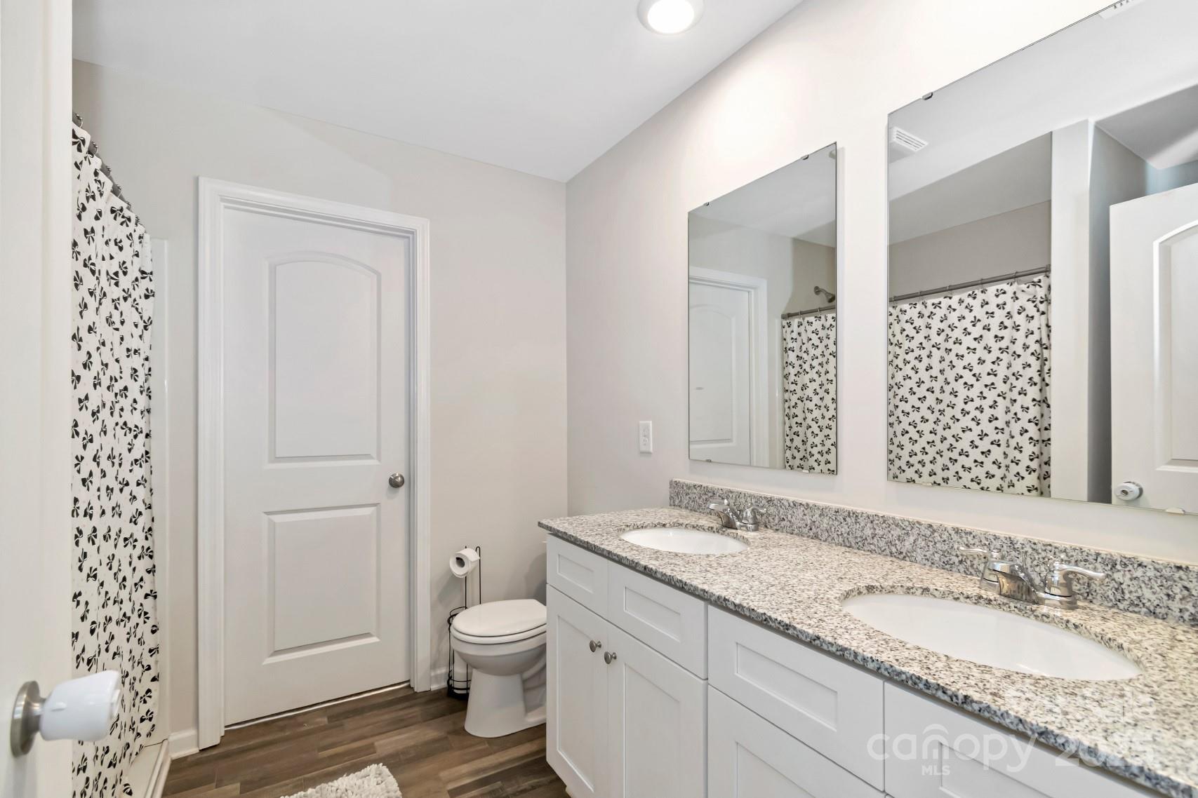 3305 Rian Drive Lenoir, NC 28645 - Photo 33 of 40 a bathroom with a granite countertop sink toilet and shower