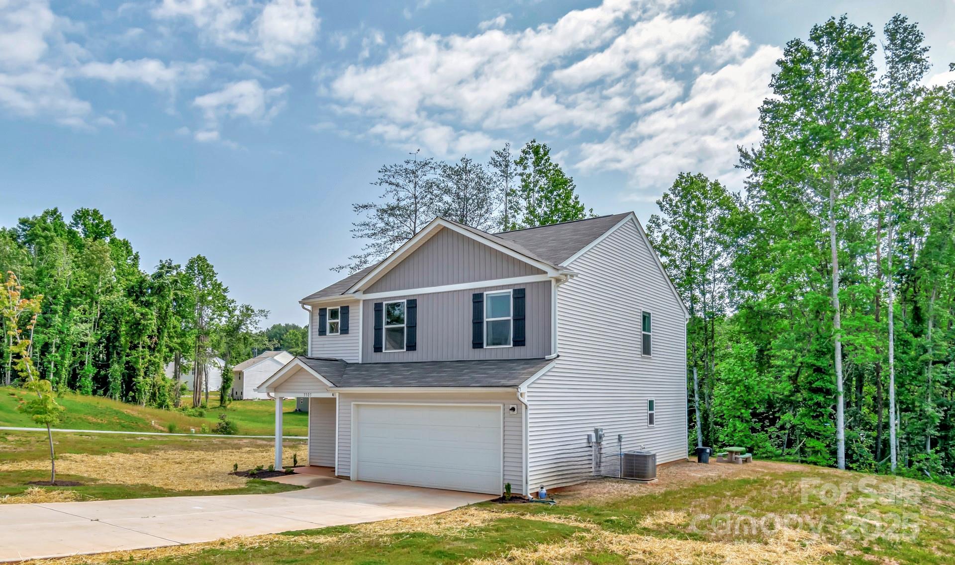 3305 Rian Drive Lenoir, NC 28645 - Photo 37 of 40 a front view of a house with a yard and garage