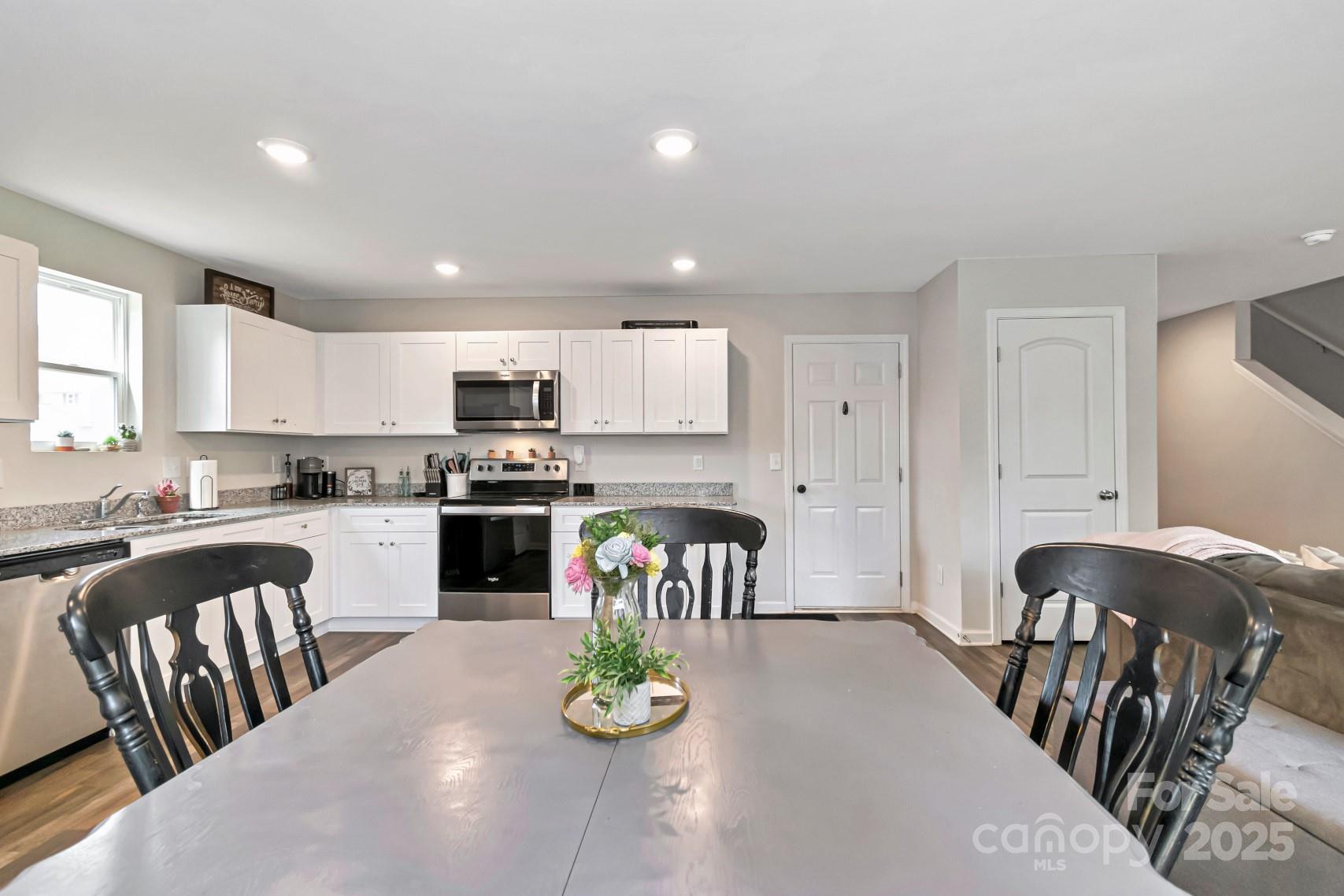 3305 Rian Drive Lenoir, NC 28645 - Photo 5 of 40 a kitchen with granite countertop stainless steel appliances a table and chairs in it