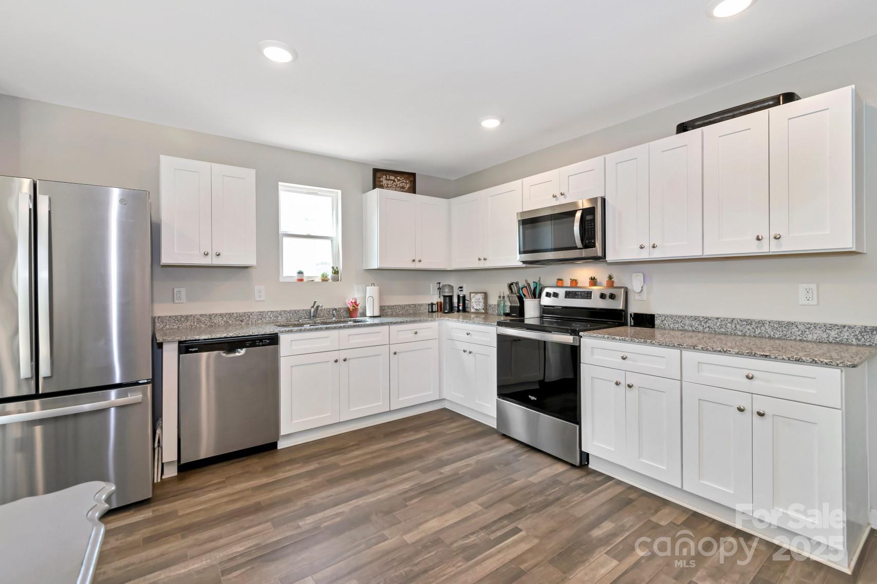 3305 Rian Drive Lenoir, NC 28645 - Photo 8 of 40 a kitchen with granite countertop white cabinets and stainless steel appliances