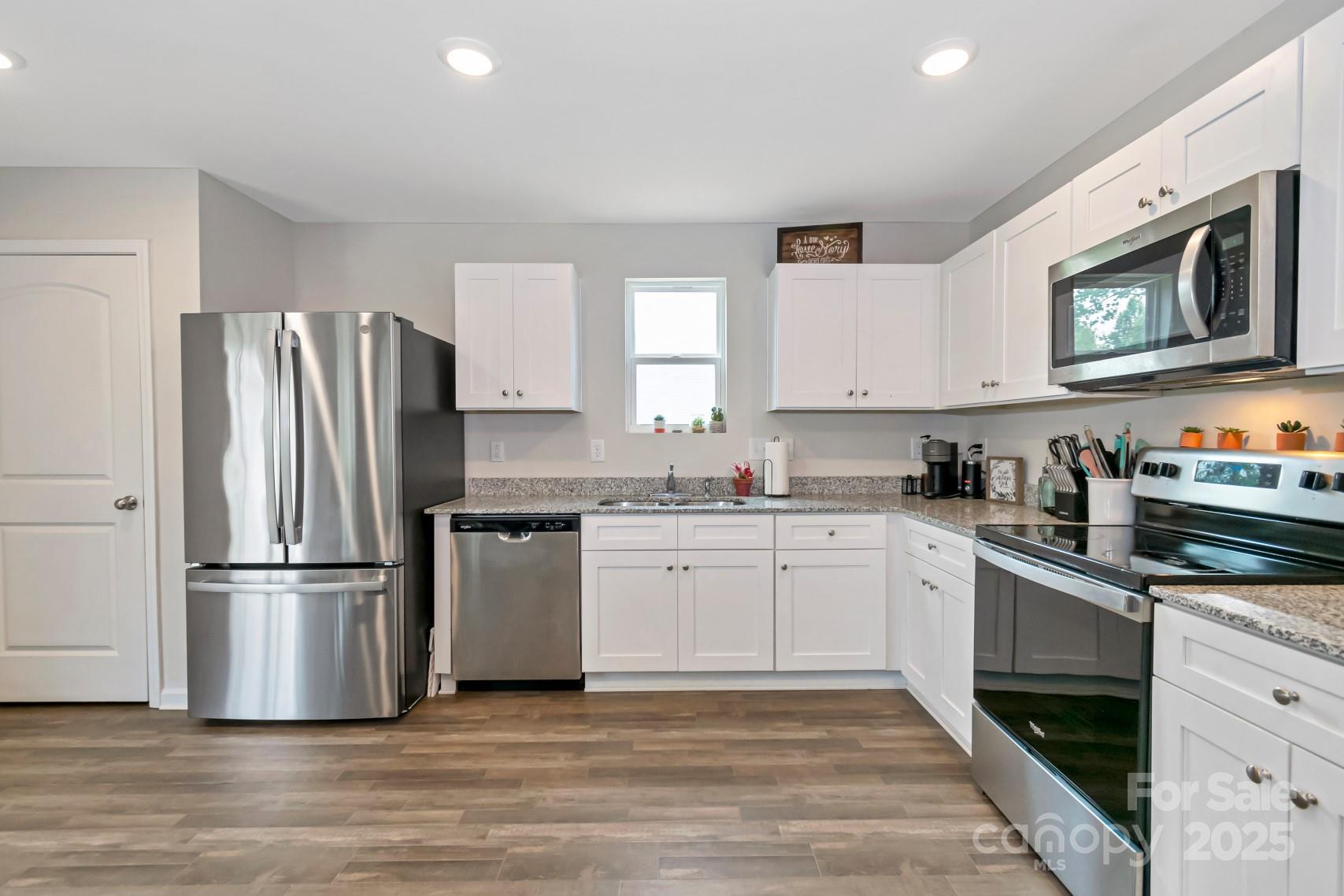 3305 Rian Drive Lenoir, NC 28645 - Photo 9 of 40 a kitchen with granite countertop a refrigerator stove and sink