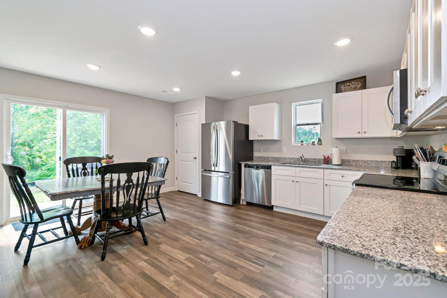 3305 Rian Drive Lenoir, NC 28645 - Photo 10 of 40 a kitchen with granite countertop kitchen island stainless steel appliances a dining table and chairs