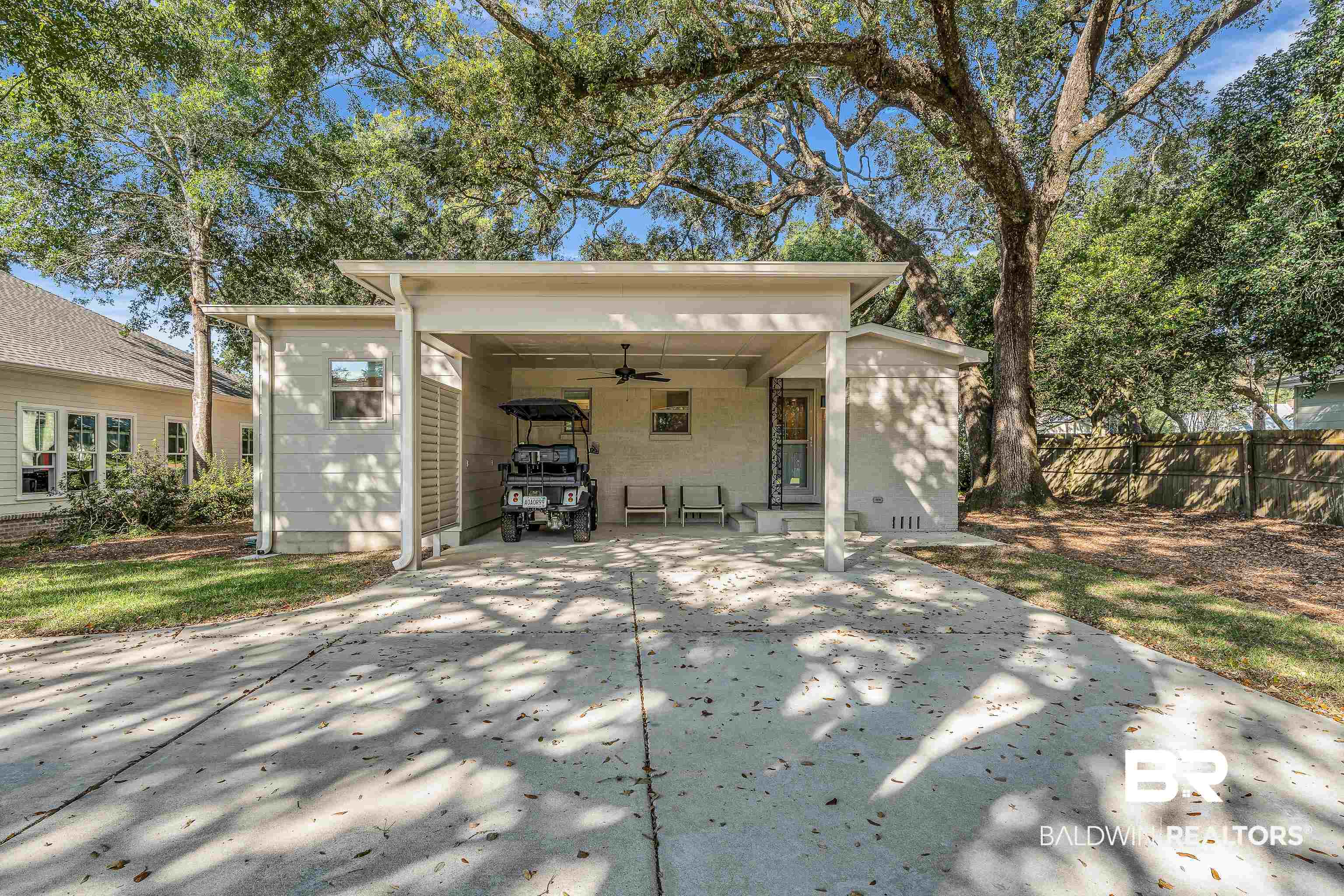 357 Azalea Street Fairhope, AL 36532 - Photo 18 of 22 Rear view of property featuring a ceiling fan, concrete driveway, and a patio area