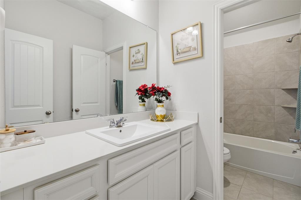 7416 Sequoia Rdg Road Little Elm, TX 76227 - Photo 32 of 37 Bathroom featuring a white vanity with an integrated sink and chrome faucet