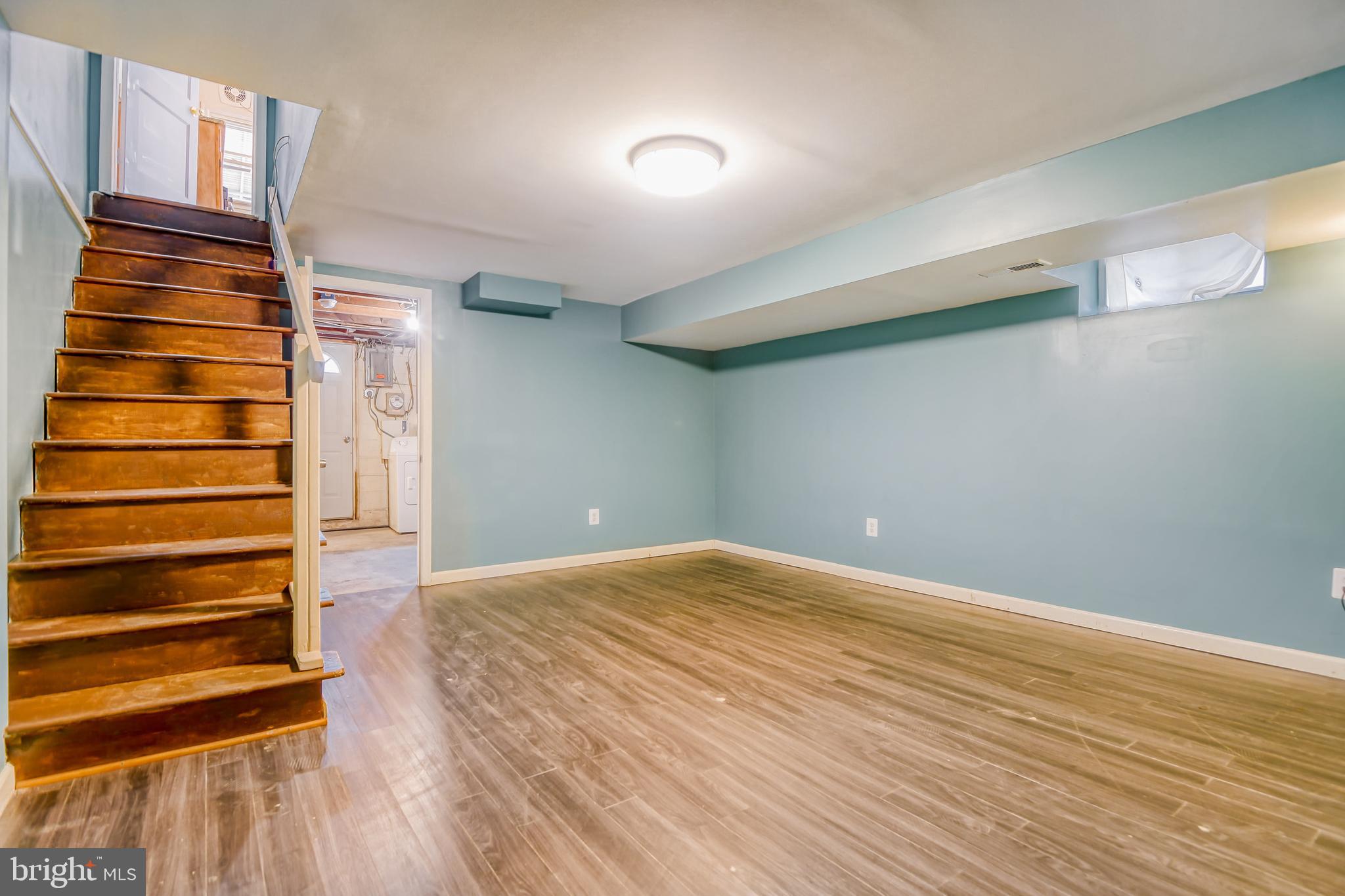 946 Middlesex Road Essex, MD 21221 - Photo 19 of 22 a view of an empty room with wooden floor and windows