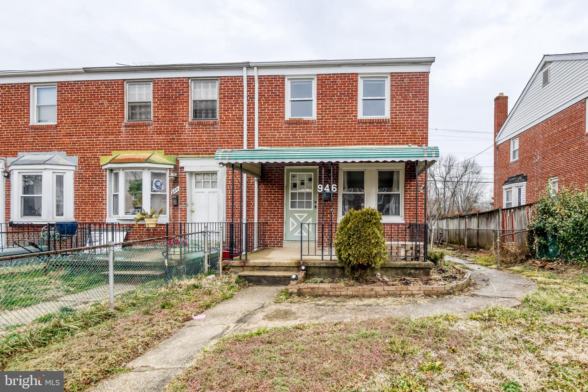 946 Middlesex Road Essex, MD 21221 - Photo 2 of 22 front view of a brick house with a chairs and table in a patio