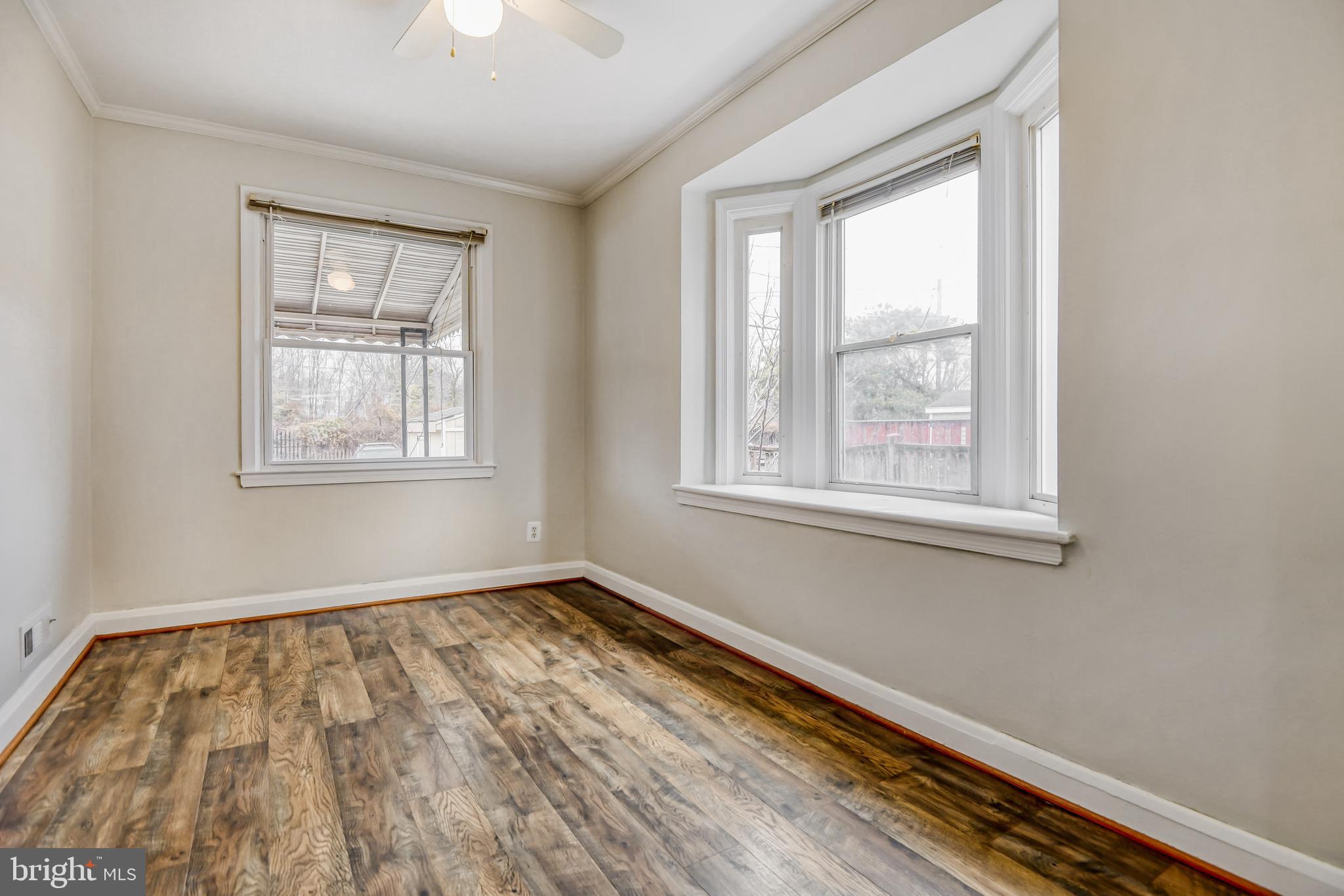946 Middlesex Road Essex, MD 21221 - Photo 6 of 22 wooden floor in an empty room with a window
