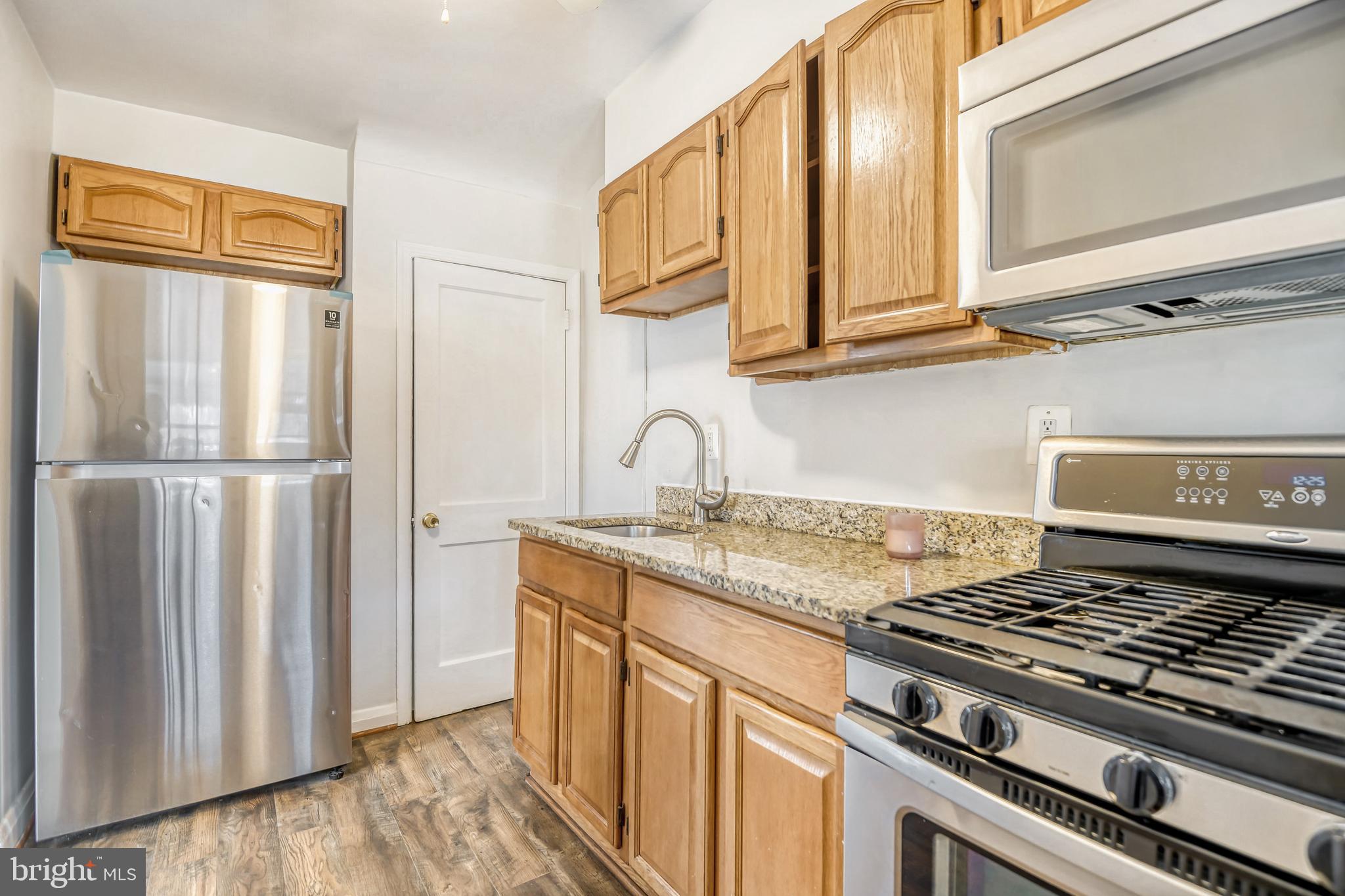 946 Middlesex Road Essex, MD 21221 - Photo 8 of 22 a kitchen with stainless steel appliances granite countertop a refrigerator and a sink