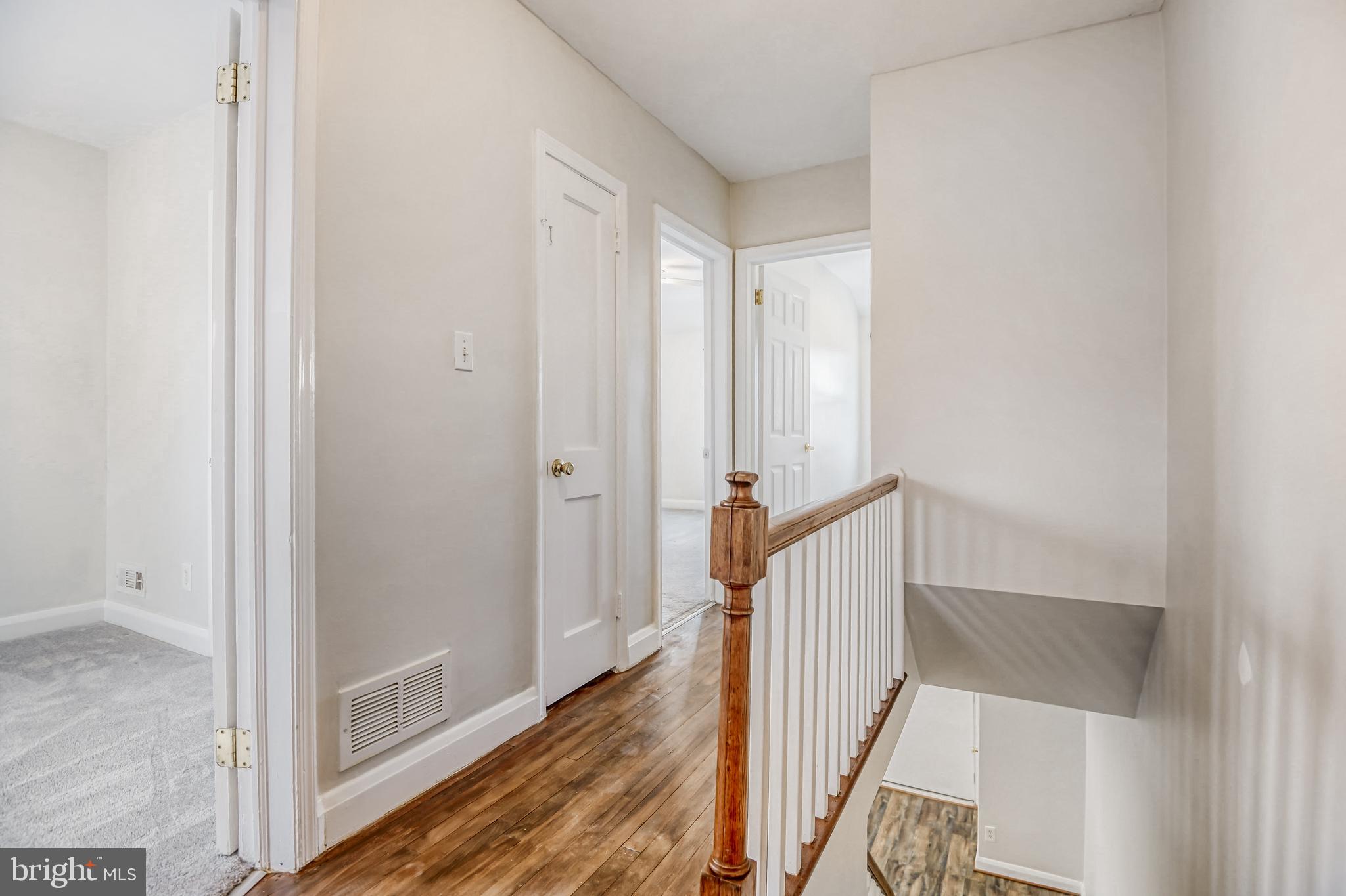 946 Middlesex Road Essex, MD 21221 - Photo 10 of 22 a view of a hallway with wooden floor and staircase