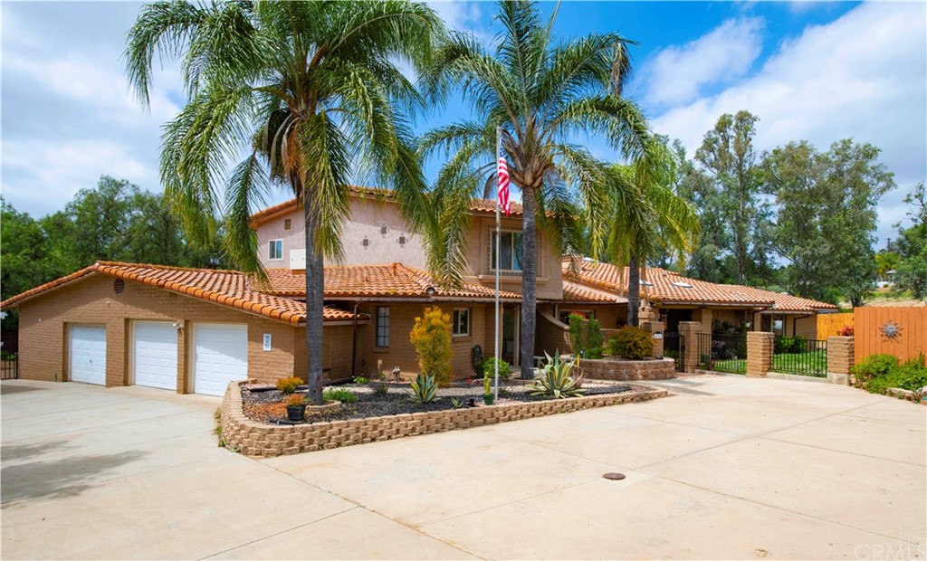 14322 Fruitvale Road Valley Center, CA 92082 - Photo 1 of 1 a view of a house with palm trees