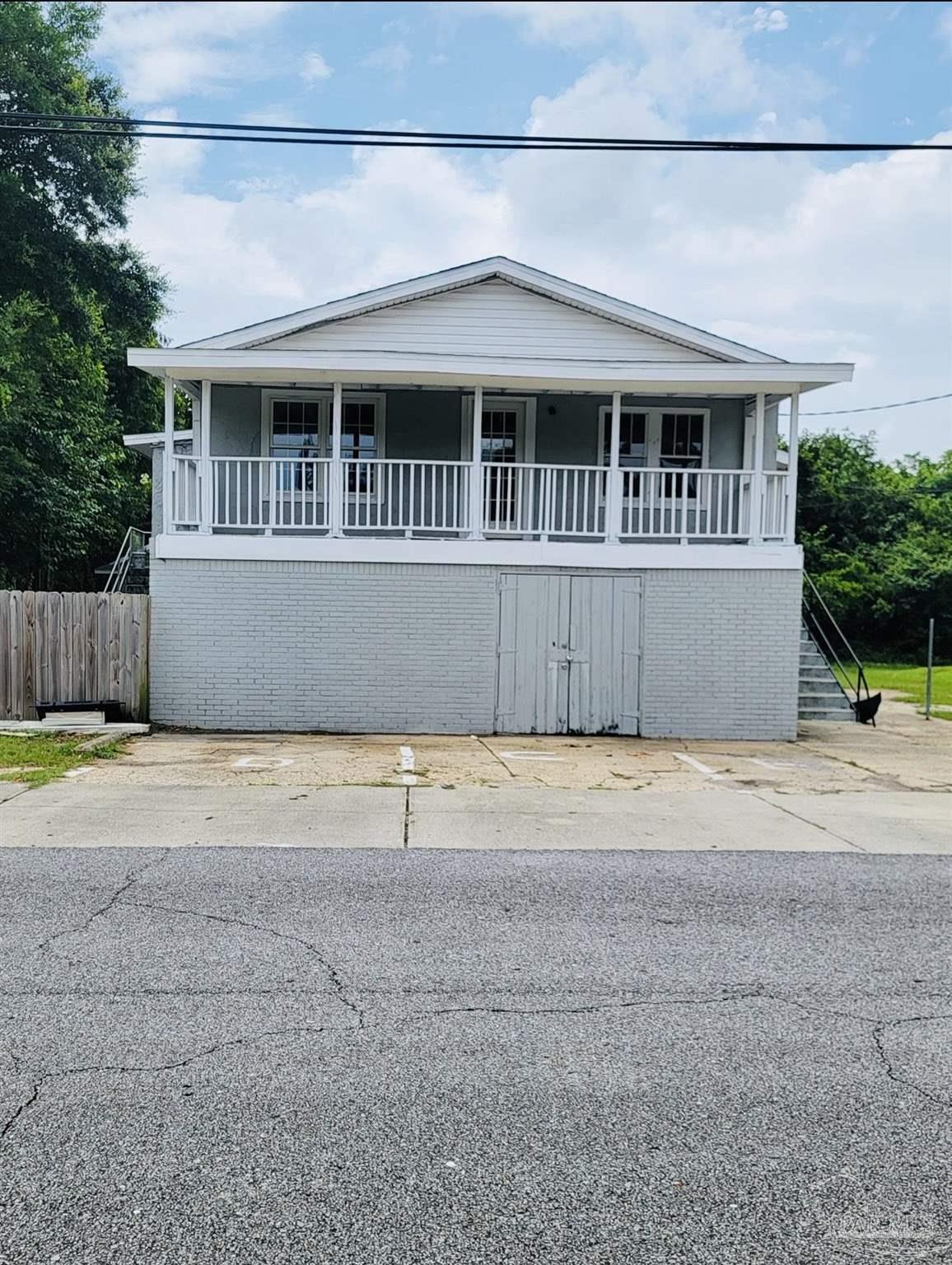 2901 North Hayne Street Pensacola, FL 32503 - Photo 1 of 11 a front view of a house with a yard and garage
