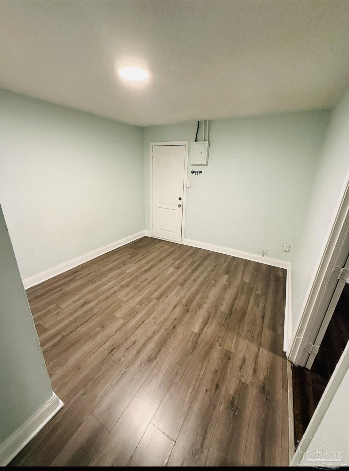 2901 North Hayne Street Pensacola, FL 32503 - Photo 11 of 11 an empty room with wooden floor and windows