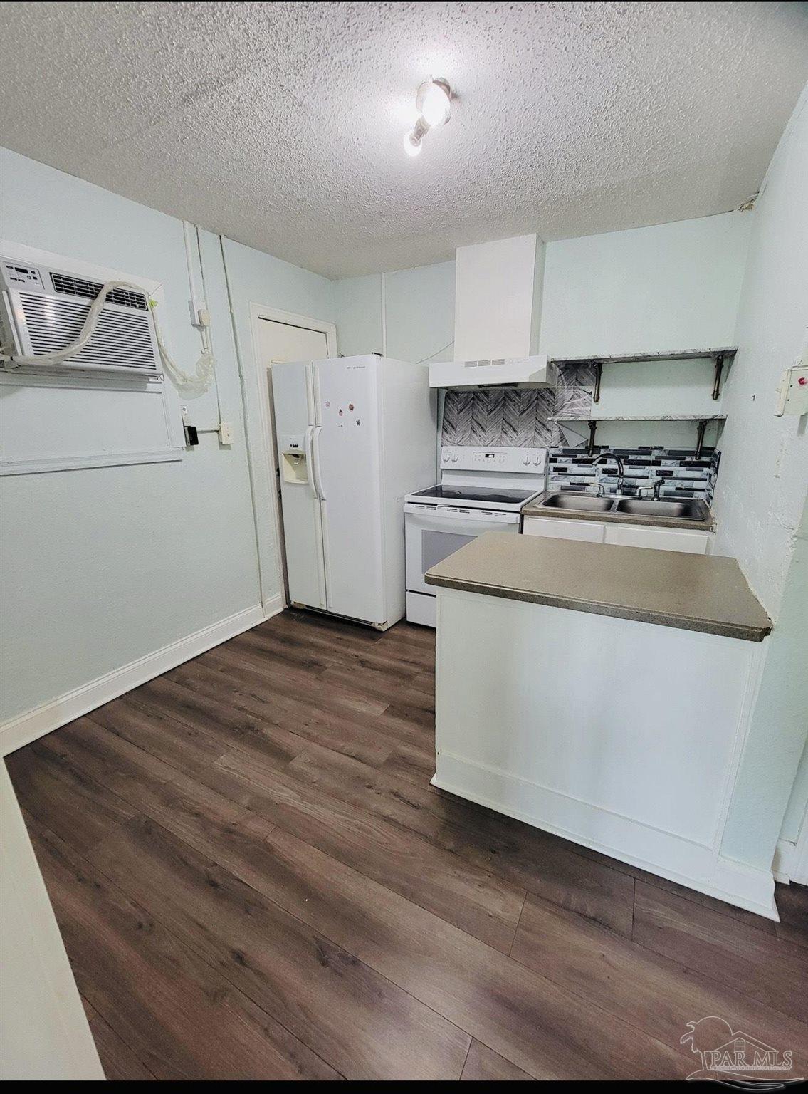 2901 North Hayne Street Pensacola, FL 32503 - Photo 3 of 11 a kitchen with stainless steel appliances granite countertop a stove a sink and a refrigerator