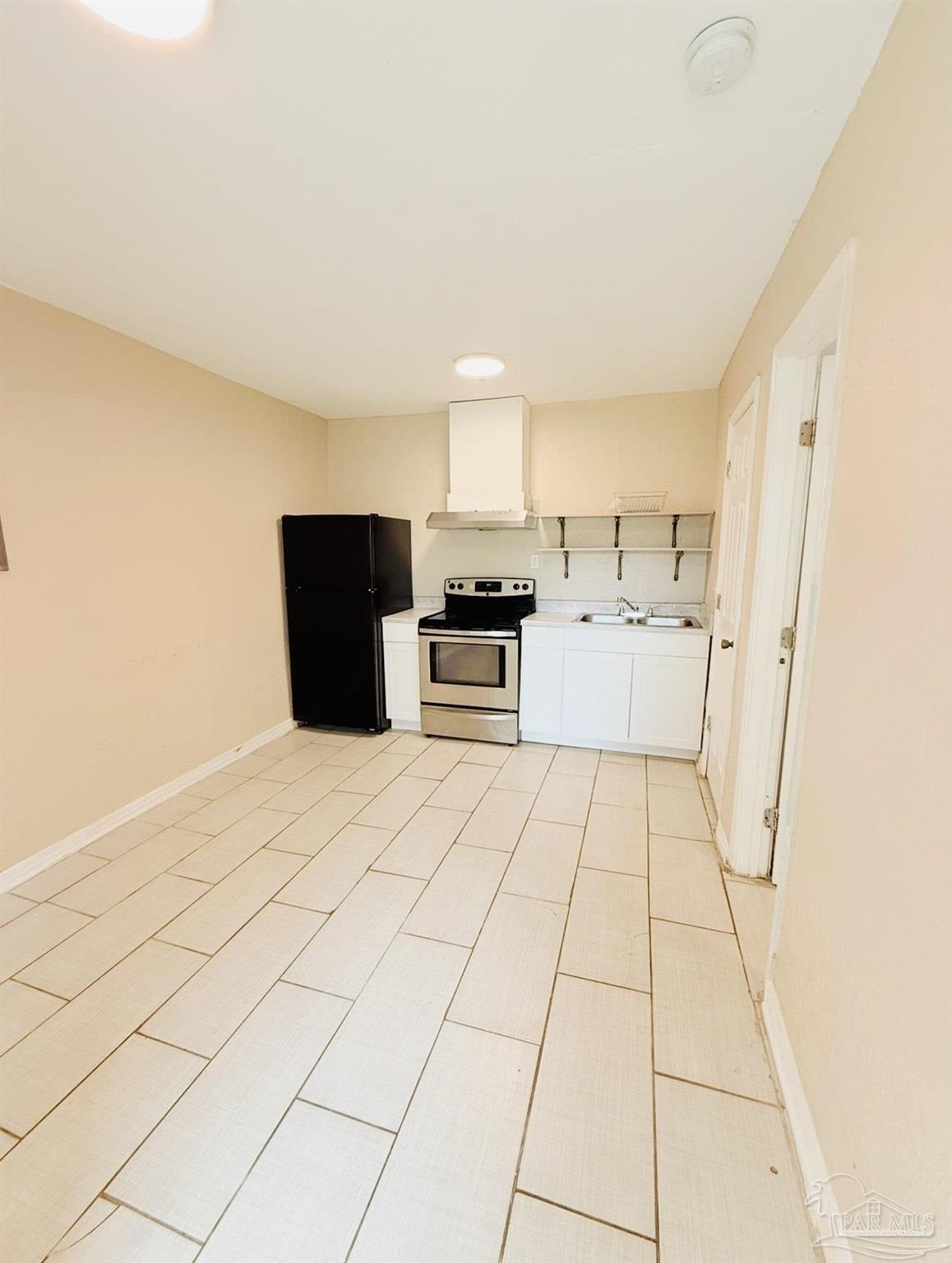 2901 North Hayne Street Pensacola, FL 32503 - Photo 5 of 11 a kitchen with a stove a refrigerator and cabinets