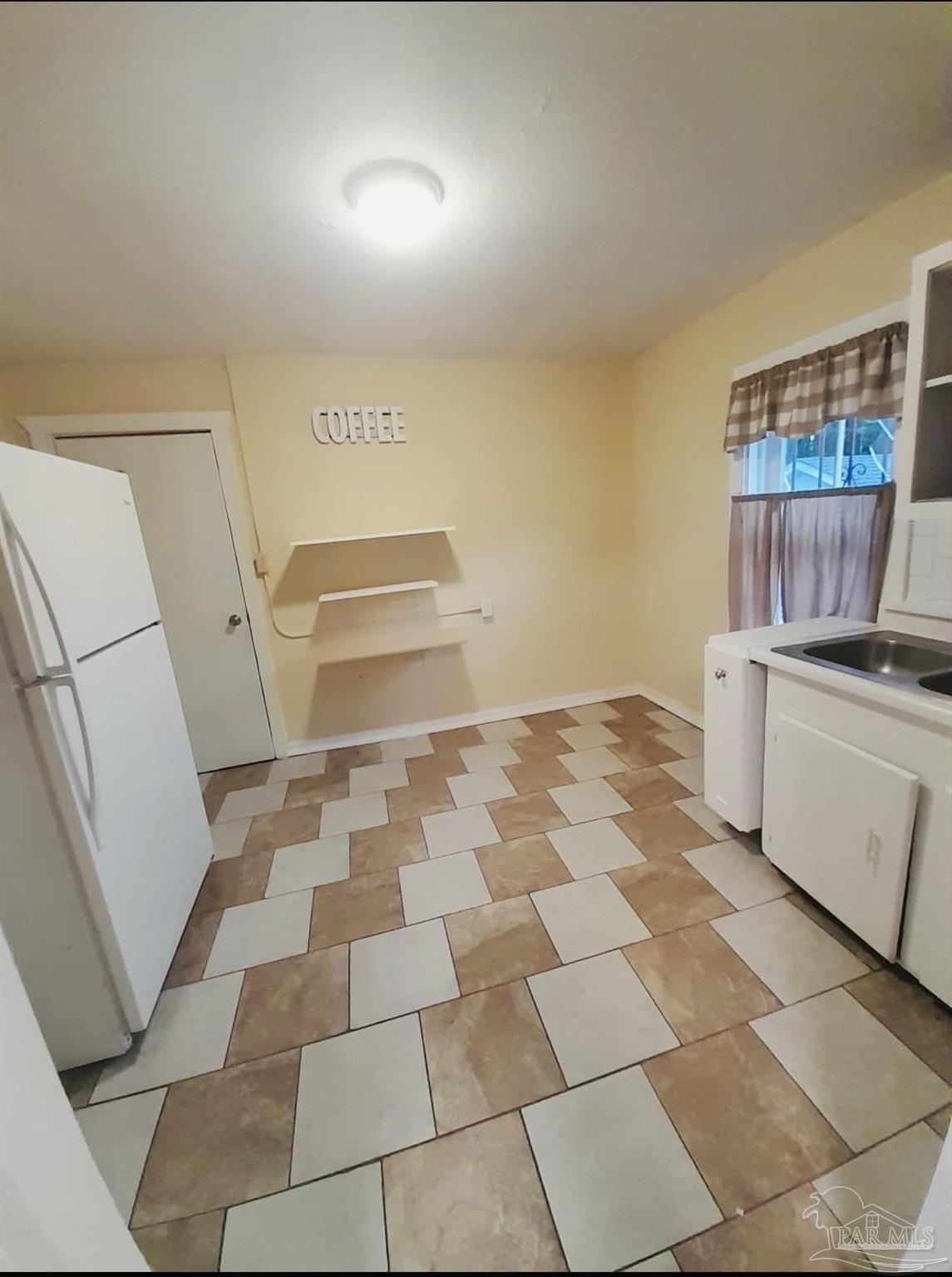 2901 North Hayne Street Pensacola, FL 32503 - Photo 10 of 11 a room with a black white checkered floor