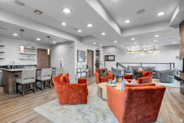 1258 Rothwell Road Park City, UT 84060 - Photo 44 of 48 Open-concept common area featuring wood-finish flooring, a built-in wet bar with stone countertops and pendant lighting, and recessed ceiling lights