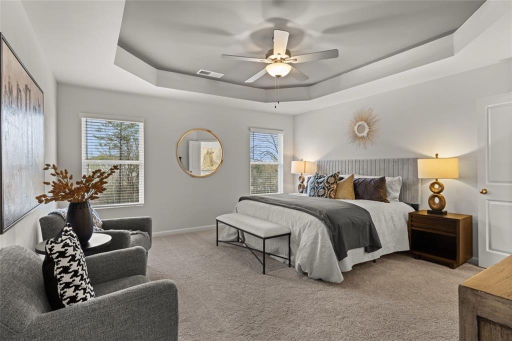 277 Epping Street, Unit 79 Stockbridge, GA 30281 - Photo 37 of 49 a spacious bedroom with a bed and a chandelier