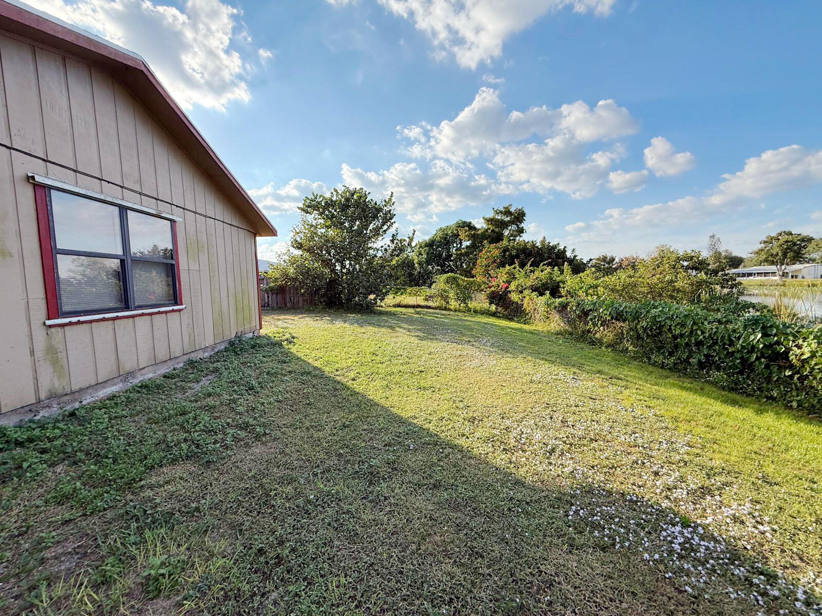 2361 Southeast 27th Street Okeechobee, FL 34974 - Photo 13 of 31 a view of a backyard with plants and large trees